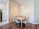 Bright dining area with a stylish chandelier and a view into the kitchen at 18045 Tarrington Pl, Hudson, FL 34667