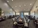 Bright dining room featuring a long table with chairs, recessed lighting, and windows for natural light at 18045 Tarrington Pl, Hudson, FL 34667
