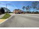 Well-maintained community entrance with a covered entry and lush landscaping at 18045 Tarrington Pl, Hudson, FL 34667