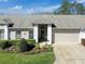 Inviting single-story home boasts a well-maintained lawn and neutral exterior paint at 18045 Tarrington Pl, Hudson, FL 34667