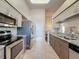 Charming kitchen with stainless steel appliances, granite counters, and tile flooring at 18045 Tarrington Pl, Hudson, FL 34667