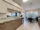 Bright eat-in kitchen featuring granite counters and views of the lanai through sliding glass doors at 18045 Tarrington Pl, Hudson, FL 34667