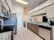 Charming kitchen with stainless steel appliances, granite counters, and tile flooring at 18045 Tarrington Pl, Hudson, FL 34667