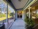 Enclosed lanai with outdoor seating and sliding glass doors to the interior at 18045 Tarrington Pl, Hudson, FL 34667