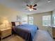 Well-lit main bedroom featuring a ceiling fan, carpeted floors, and natural light at 18045 Tarrington Pl, Hudson, FL 34667