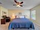 Well-lit main bedroom featuring a ceiling fan, carpeted floors, and bedside tables at 18045 Tarrington Pl, Hudson, FL 34667