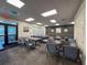 Carpeted meeting room features tables, chairs, and bright lighting, great for gatherings or office space at 18045 Tarrington Pl, Hudson, FL 34667