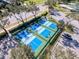 Aerial view of new pickleball courts with lush landscaping in a vibrant, active community at 18045 Tarrington Pl, Hudson, FL 34667