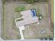 Overhead aerial view of the property, featuring a screened pool and boat parking at 18317 Treehaven Dr, Hudson, FL 34667