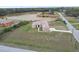 Aerial view of the house with large yard, lake, and long driveway surrounded by trees at 18317 Treehaven Dr, Hudson, FL 34667