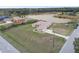 Single-story home with an attached garage and long driveway near a lake at 18317 Treehaven Dr, Hudson, FL 34667