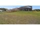 Backyard featuring a screened lanai and a wooden fence at 18317 Treehaven Dr, Hudson, FL 34667