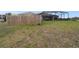 The backyard has a wooden fence and screened in patio at 18317 Treehaven Dr, Hudson, FL 34667