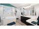 Relax in this bathroom featuring a large tub, walk in shower and double sinks at 18317 Treehaven Dr, Hudson, FL 34667