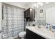 Bathroom features a marble vanity, large mirror, and a shower with a stylish curtain at 18317 Treehaven Dr, Hudson, FL 34667