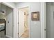 Bright bathroom entrance with a shower and white door for privacy at 18317 Treehaven Dr, Hudson, FL 34667