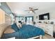 Spacious bedroom with teal accents, a bed, and a view of the desk at 18317 Treehaven Dr, Hudson, FL 34667