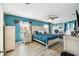 Bright bedroom with teal walls, a bed, and large windows for ample natural light at 18317 Treehaven Dr, Hudson, FL 34667
