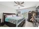 Bright bedroom featuring a ceiling fan, window overlooking pool and furnishings at 18317 Treehaven Dr, Hudson, FL 34667
