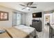 Bedroom features a ceiling fan, backyard view, and dresser storage at 18317 Treehaven Dr, Hudson, FL 34667