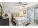 Comfortable bedroom with neutral tones, a ceiling fan, and a view to the backyard at 18317 Treehaven Dr, Hudson, FL 34667