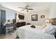 Bright bedroom with a comfortable bed, dresser, television, and a makeup table at 18317 Treehaven Dr, Hudson, FL 34667