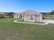 Beautifully landscaped yard complements this expansive single-Gathering home with concrete walkway at 18317 Treehaven Dr, Hudson, FL 34667