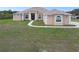 Charming single-story home with stucco exterior, manicured lawn, and decorative window trim at 18317 Treehaven Dr, Hudson, FL 34667