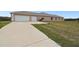 Spacious home featuring a two-car garage and a wide driveway at 18317 Treehaven Dr, Hudson, FL 34667