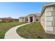 Elegant home with a columned entrance and a curved walkway leading to the front door at 18317 Treehaven Dr, Hudson, FL 34667