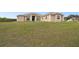 Charming single story home featuring a large yard, neutral stucco exterior, and a columned front entry at 18317 Treehaven Dr, Hudson, FL 34667