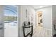 Hallway with pool access features a table and a bathroom entrance at 18317 Treehaven Dr, Hudson, FL 34667