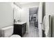 Hallway between a bathroom and other rooms. Featuring hardwood floors at 18317 Treehaven Dr, Hudson, FL 34667