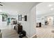 Hallway featuring modern decor, neutral tones, and an open floor plan leading into the kitchen at 18317 Treehaven Dr, Hudson, FL 34667