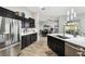 Kitchen with stainless steel appliances, marble countertops, and modern lighting and fixtures at 18317 Treehaven Dr, Hudson, FL 34667