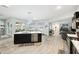 Spacious kitchen with stainless steel appliances, open layout, large island, and modern fixtures at 18317 Treehaven Dr, Hudson, FL 34667