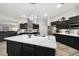 Kitchen boasts a large island, stainless steel appliances, marble countertops, and modern lighting at 18317 Treehaven Dr, Hudson, FL 34667