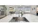 Kitchen island with a stainless steel sink, marble countertops, and modern faucet fixtures at 18317 Treehaven Dr, Hudson, FL 34667