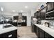Kitchen features stainless steel appliances, black cabinets, marble countertops, and modern backsplash at 18317 Treehaven Dr, Hudson, FL 34667