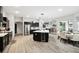 Bright and airy kitchen with a large island, stainless steel appliances, and dark cabinetry at 18317 Treehaven Dr, Hudson, FL 34667