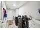 Convenient laundry room equipped with a washer, dryer, and utility sink at 18317 Treehaven Dr, Hudson, FL 34667