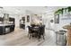 Open living area with hardwood floors connecting the kitchen, nook, and entry at 18317 Treehaven Dr, Hudson, FL 34667