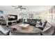 Cozy living room with stylish furniture, ceiling fan, and streaming television set at 18317 Treehaven Dr, Hudson, FL 34667