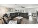 Spacious living room featuring modern gray sectional, ceiling fan, and elegant decor at 18317 Treehaven Dr, Hudson, FL 34667