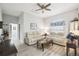 Comfortable living room featuring hardwood floors, modern furniture, and a ceiling fan at 18317 Treehaven Dr, Hudson, FL 34667
