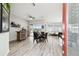 Inviting open-concept area with stylish flooring, bar area, and seamless access to outdoor living spaces at 18317 Treehaven Dr, Hudson, FL 34667