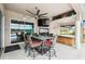 Covered patio area with a dining set, ceiling fan, and a view of the lake at 18317 Treehaven Dr, Hudson, FL 34667