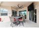 Covered patio area with a dining set, ceiling fan, and a view of the backyard at 18317 Treehaven Dr, Hudson, FL 34667