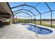 Screened-in pool featuring a patio area with a lake view at 18317 Treehaven Dr, Hudson, FL 34667