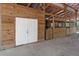 Interior barn with stalls for livestock and double doors to the exterior at 19263 Quiet Oak Ln, Brooksville, FL 34604